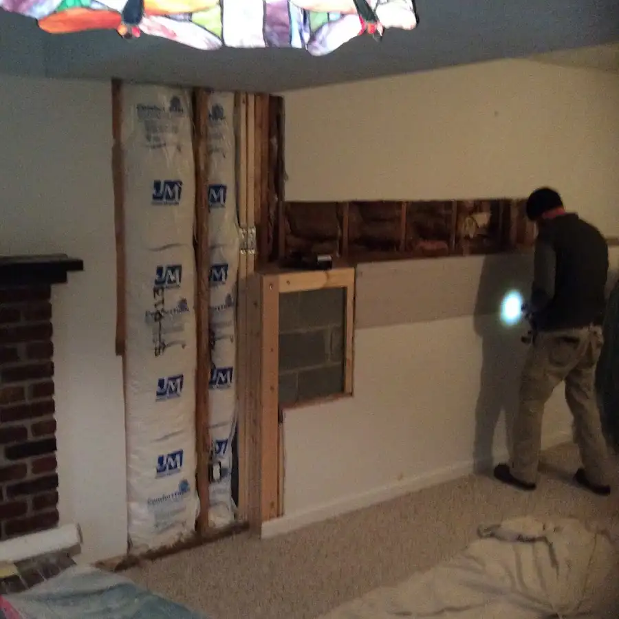 Restoration technician inspecting water damage in Hickam Housing